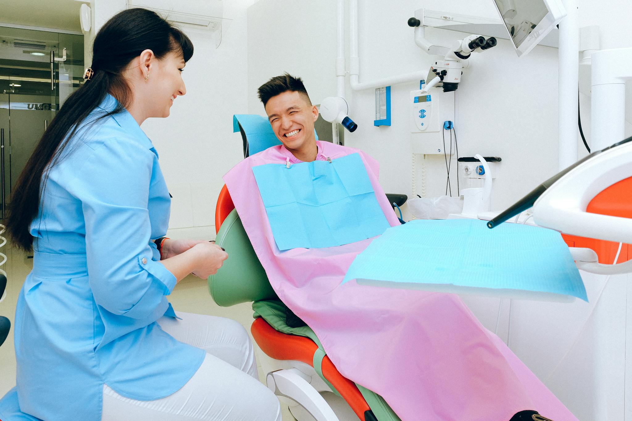 About 12 cheerful ethnic male patient sitting in dental
