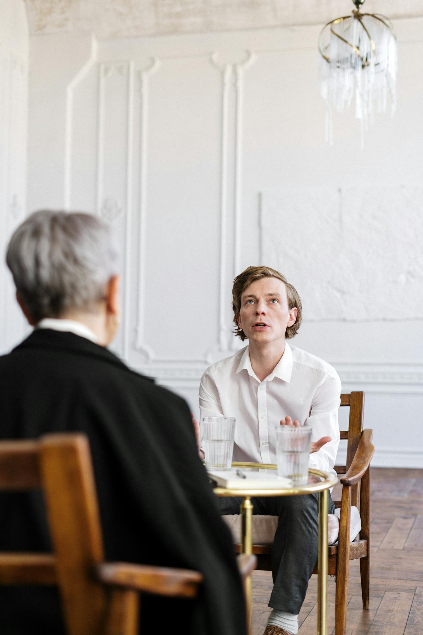 man in black suit sitting beside woman