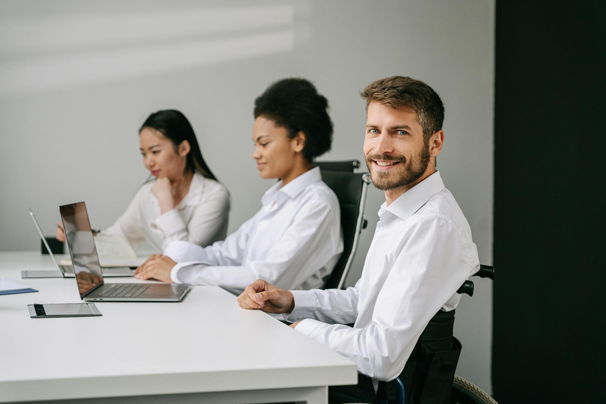 man sitting at a table with laptop